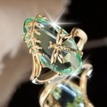 Golden dragonfly ring featuring a large oval green gemstone and delicate leaf accents - US 6 / Green