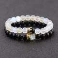 Close-up of moonstone and matte black couple crown bracelets with gold pave details - Small Crown Set (NBCB009+10A)