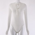Detailed close-up of white ribbed knit fabric texture and snap buttons on long sleeve bodysuit - L / White