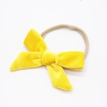 Close-up of yellow velvet bow on soft elastic nylon headband for babies and toddlers - Yellow