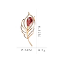Detailed view of a gold-toned feather brooch with red crystals, measuring 6.3cm by 2.6cm - C1048 Red Gem Leaf