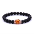 Lava rock beaded bracelet with rose gold crown and amber-colored center bead - Volcanic Stone Rose Gold