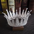 Detailed close-up of a vintage silver bridal tiara with sparkling rhinestones on old books - Silver