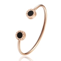 Detailed macro view of rose gold stainless steel bangle with Roman numerals and black inlay - Rose Gold