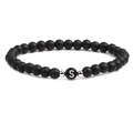 Detailed close-up of 6mm matte black stone beads with silver spacers and letter S bead - Letter S