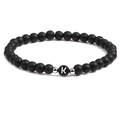 Detail of 6mm matte black stone beaded bracelet featuring silver spacers and letter K charm - Letter K
