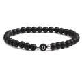 Detailed close-up of 6mm black matte stone beads with white letter O charm and silver spacers - Letter O