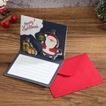 3D pop-up Santa Claus Christmas card in navy blue with a matching red envelope - Santa Claus with Gift