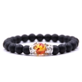 Matzwarte kralenarmband met zilveren kroon, zirkonia steentjes en oranje kleuraccenten - Matte Barnsteen Witgouden Kroon