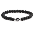 Close-up of 6mm black matte beads bracelet featuring a silver-toned letter R charm - Letter R