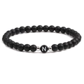 Detail shot of black matte beaded bracelet featuring a white letter N on a central bead - Letter N