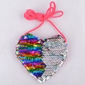 Macro shot of heart-shaped mini sequin bag with rainbow and silver details on white background - Colorful Silver