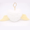 Detail shot of heart-shaped plush keychain with white wings and golden metal ring - Gold Keychain / White