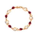 Elegant rose gold heart bracelet with red pear-cut stones and micro-pave zircons - Fuschia
