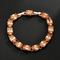 Elegante roségouden armband met ovaal geslepen oranje-gele zirkonia edelstenen - Champagne
