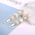 Close-up of golden hairpins with marble stones on a minimalist decorative background - Round Gold