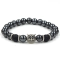Detailed shot of hematite and lava stone beads featuring a silver owl charm and spacers - Owl / Antique Silver