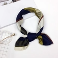 Silk neck scarf with blue and green geometric patterns laid flat on a white surface - Striped Green