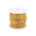 Macro detail of bulk gold snake bone chain roll wound on white plastic spool - 1.2mm / Gold