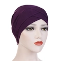 Close-up of deep purple elastic turban hat with pleated cross-front design on mannequin - Deep purple