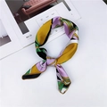 Elegant silk scarf with purple and yellow geometric patterns tied on white background - Yellow Green Purple Geometric