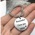 Close-up of hand holding a silver stainless steel heart ring keychain with MOM engraving - Mom Heart Keychain / 25mm Pendant