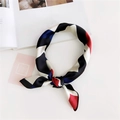 Silky geometric square scarf in black, white, red, and blue blocks with a tied knot detail - Navy Plaid