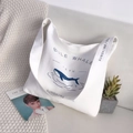 White canvas tote bag featuring blue whale illustration and spacious shoulder strap design - Whale Pattern
