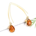 Elegant gold drop earrings with faceted amber crystal pendants for a minimalist look - Orange