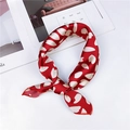 Red silk twilly scarf with white floral patterns tied in a stylish knot design - Red White Petal