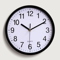 Minimalist 10 inch round black plastic wall clock with white dial and quartz movement - Black