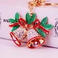 Golden Christmas bell keychain with red rhinestone bow and green holly leaves decoration - White