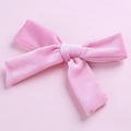 Detailed macro view of a 5-inch pink velvet bow hair clip showing soft fabric texture - Pink