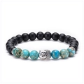 Macro detail of natural blue imperial stone and matte black beads with silver Buddha head - Buddha Head - Antique Silver