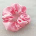 Close-up of pink satin scrunchie showing smooth silk texture and soft pleat details - Nude Pink