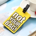 Yellow PVC luggage tag with NOT YOUR BAG text and black silicone strap accessory - Not Your Bag / Yellow