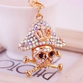 Golden pirate skull keychain with colorful rhinestones and crossbones pendant - Clear Multicolor