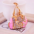 Pink handbag keychain with floral design and sparkling rhinestones on golden chain - Pink