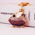 Creative flying pig keychain with gradient purple rhinestones and golden wings - Purple