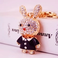 Golden rabbit keychain with sparkling rhinestones wearing a black dress detail - Black