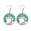 Handmade bronze tree of life earrings featuring natural green crystal chips on white background - Amazonite
