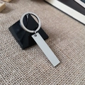 Rectangle stainless steel keychain with silver tag on black stand and burlap background - 44*10 Rectangle Silver Tag