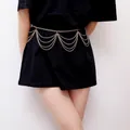 Detail view of multi-layer gold chain waist belt with cascading fringe on black dress - 03 Gold Tassel
