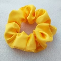 Elegant yellow satin scrunchie hair tie with a smooth glossy texture for women - Gold Yellow