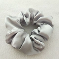 Elegant silver satin scrunchie with a glossy silk-like finish and soft pleated texture - Silver