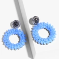 Detail of blue beaded hoop earrings with rhinestone studs on modern white pedestals - erp45 Blue