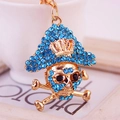 Golden pirate skull keychain with sparkling blue rhinestones and crown detail - Blue