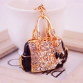 Golden handbag keychain with white flower and sparkling crystal rhinestones charm - Black