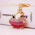 Creative gold flying pig keychain with sparkling pink and clear rhinestones - Red