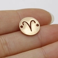 Golden round Aries zodiac pendant with double holes shown on finger detail - Aries Style (Rose Gold 1)